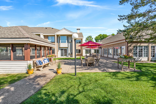 A tranquil outdoor courtyard featuring comfortable seating and well-maintained landscaping.