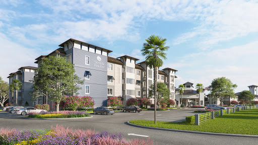 A modern residential complex surrounded by lush landscaping.
