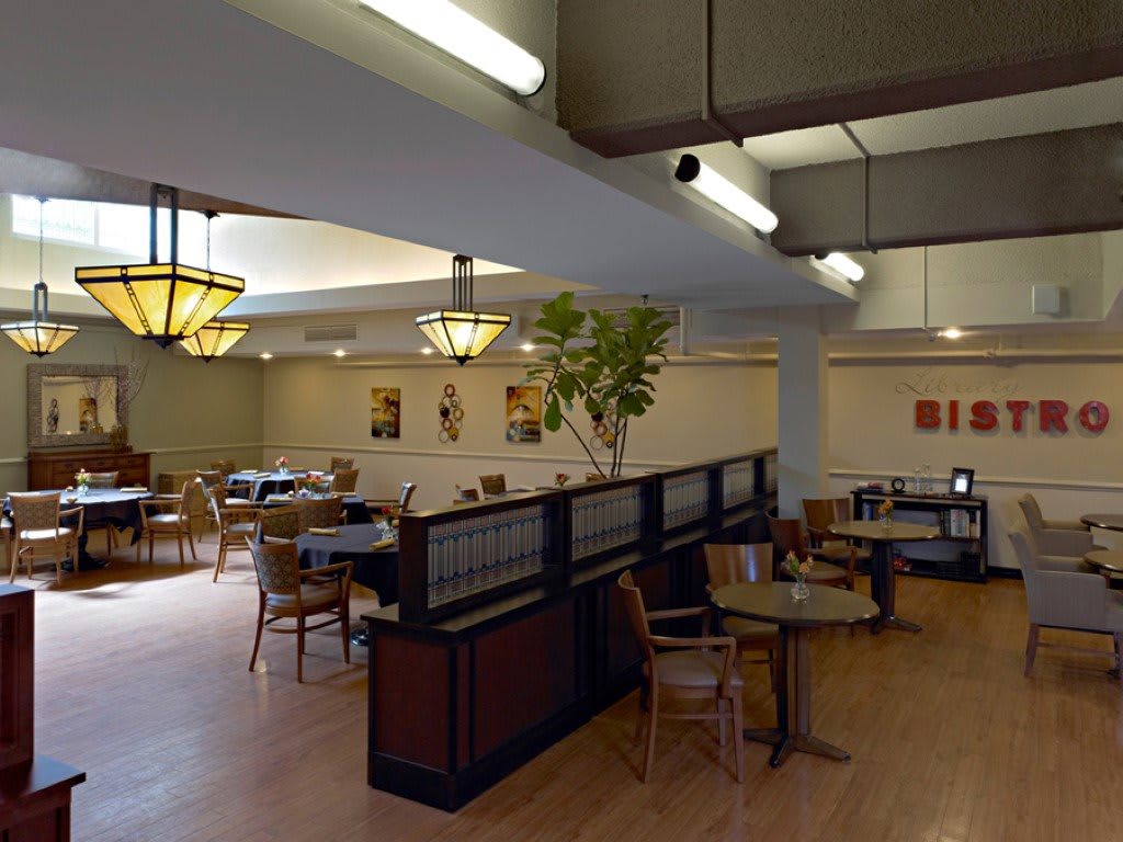 An empty restaurant interior with tables and chairs neatly arranged.