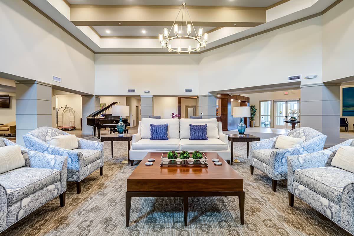 A luxurious living room featuring modern interior design with elegant furniture and a grand chandelier.