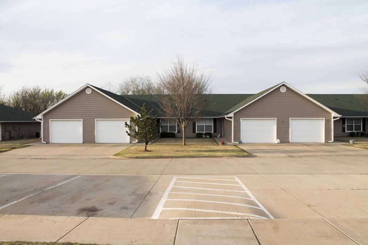 A suburban house with two garages and a central driveway.