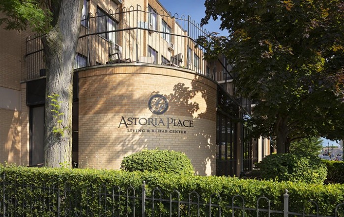 The exterior of Astoria Palace Hotel, showcasing its architectural design and surrounding greenery.