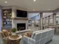 Modern living room with a fireplace, television, and comfortable seating.