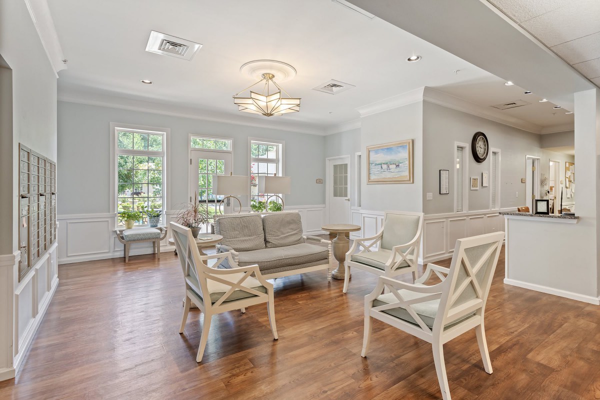 A bright and cozy living room with elegant furniture and wooden flooring.