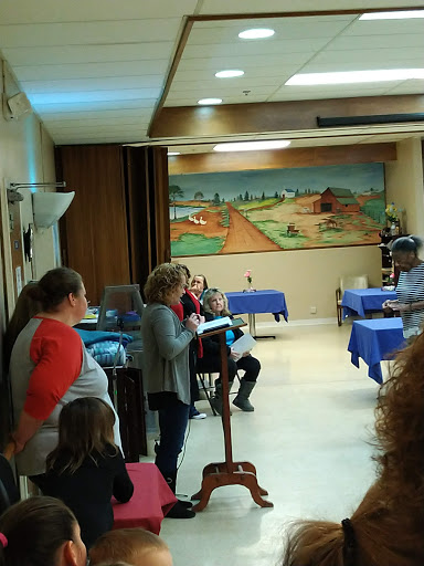 A community meeting in progress with attendees engaged in a discussion.