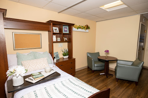 A cozy and well-furnished living space with a bed, seating area, and decorative elements.