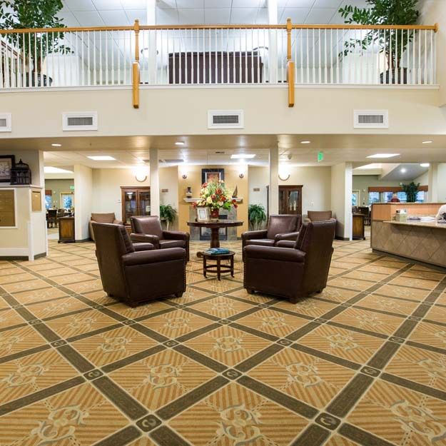 A spacious lobby with comfortable seating and a reception desk.