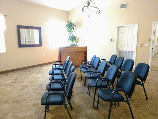A clean and organized waiting room with blue chairs and a welcoming atmosphere.
