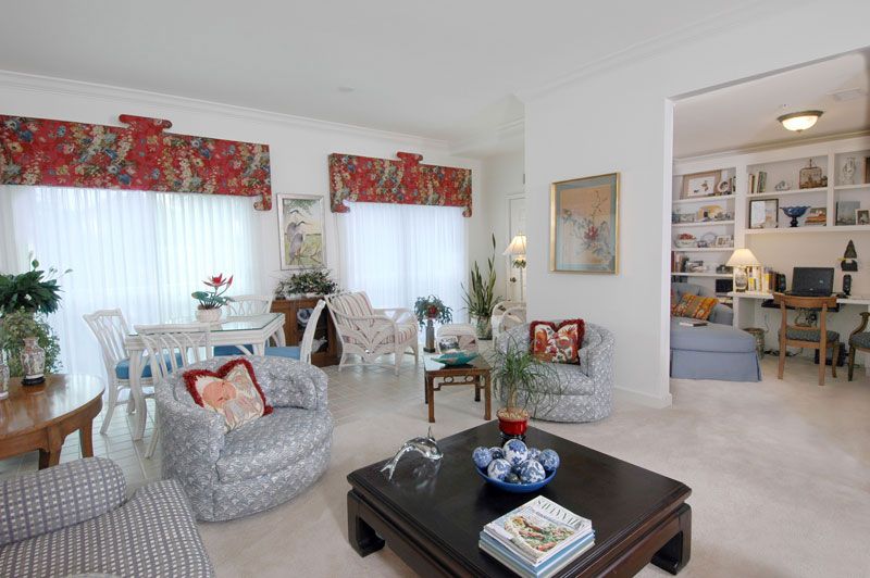 A cozy and elegantly designed living room with stylish furniture and vibrant curtains.