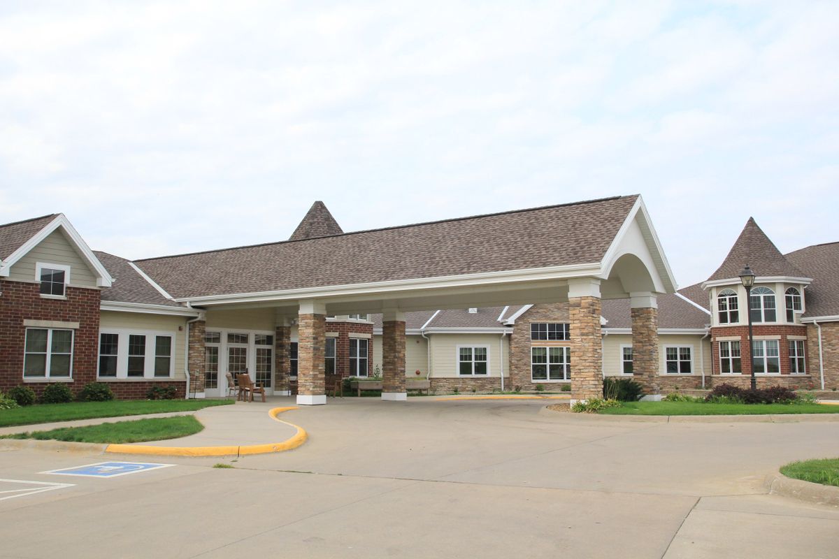 A building with a prominent entrance and sloped roof.