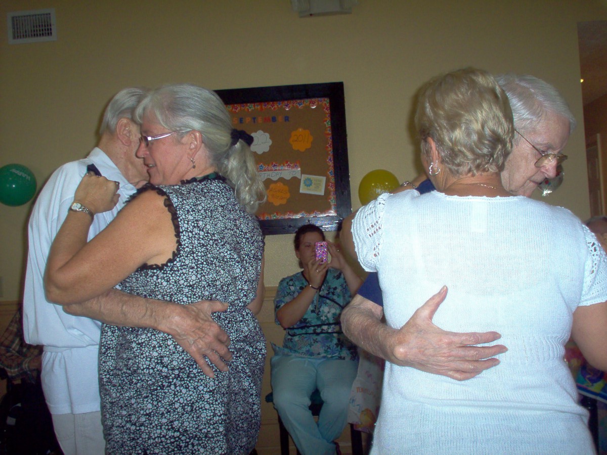 Couples enjoy dancing at a social gathering.