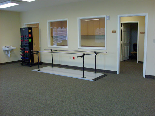 A ballet bar setup in a spacious dance studio.