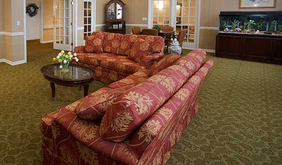 A cozy living room with floral patterned sofas and elegant furniture.