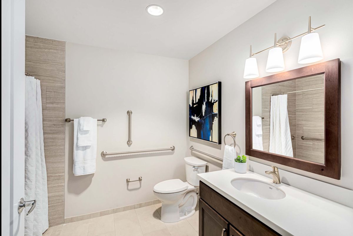A modern bathroom with a sink, toilet, and stylish decor.
