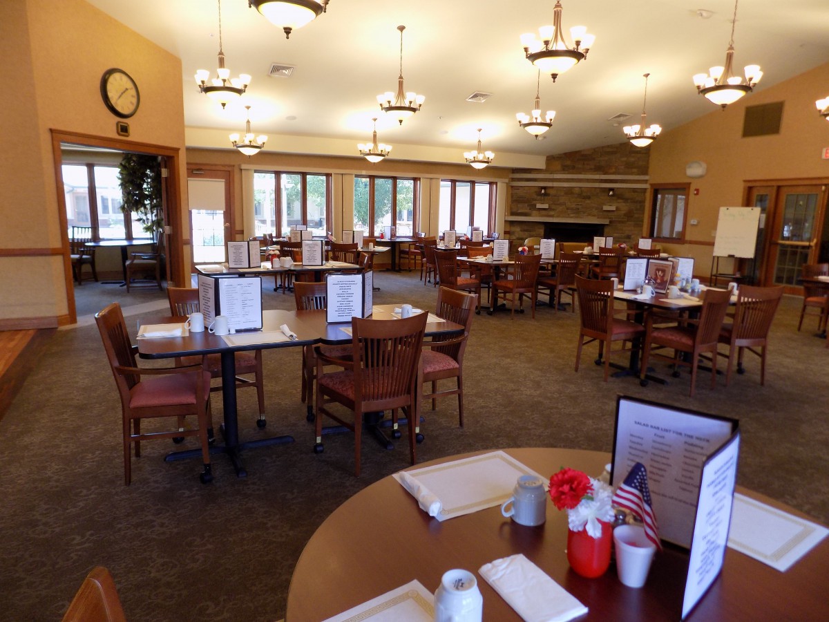 An empty restaurant dining area with neatly arranged tables and chairs.
