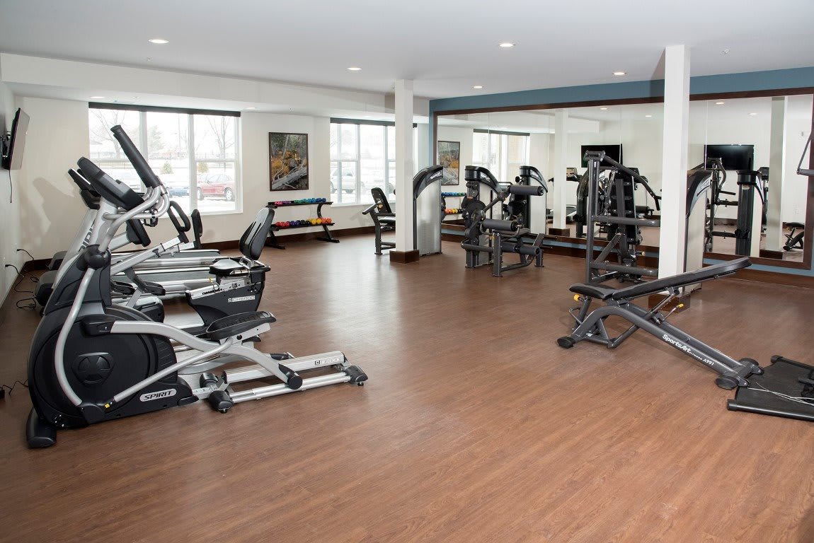 A modern indoor gym with various exercise equipment.