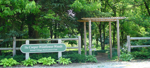 The welcoming entrance to Wildflower Woods, surrounded by lush greenery.