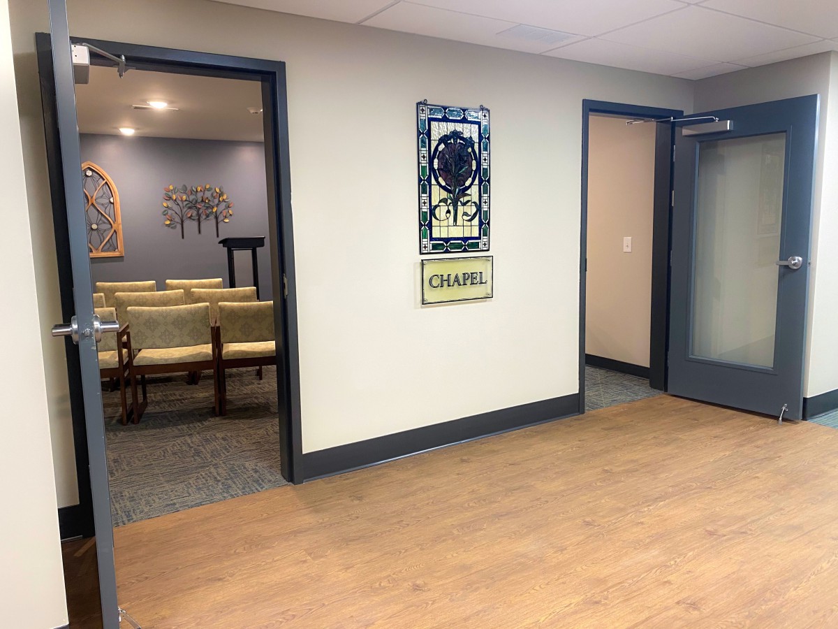 An office waiting area with chairs and artwork on the walls.