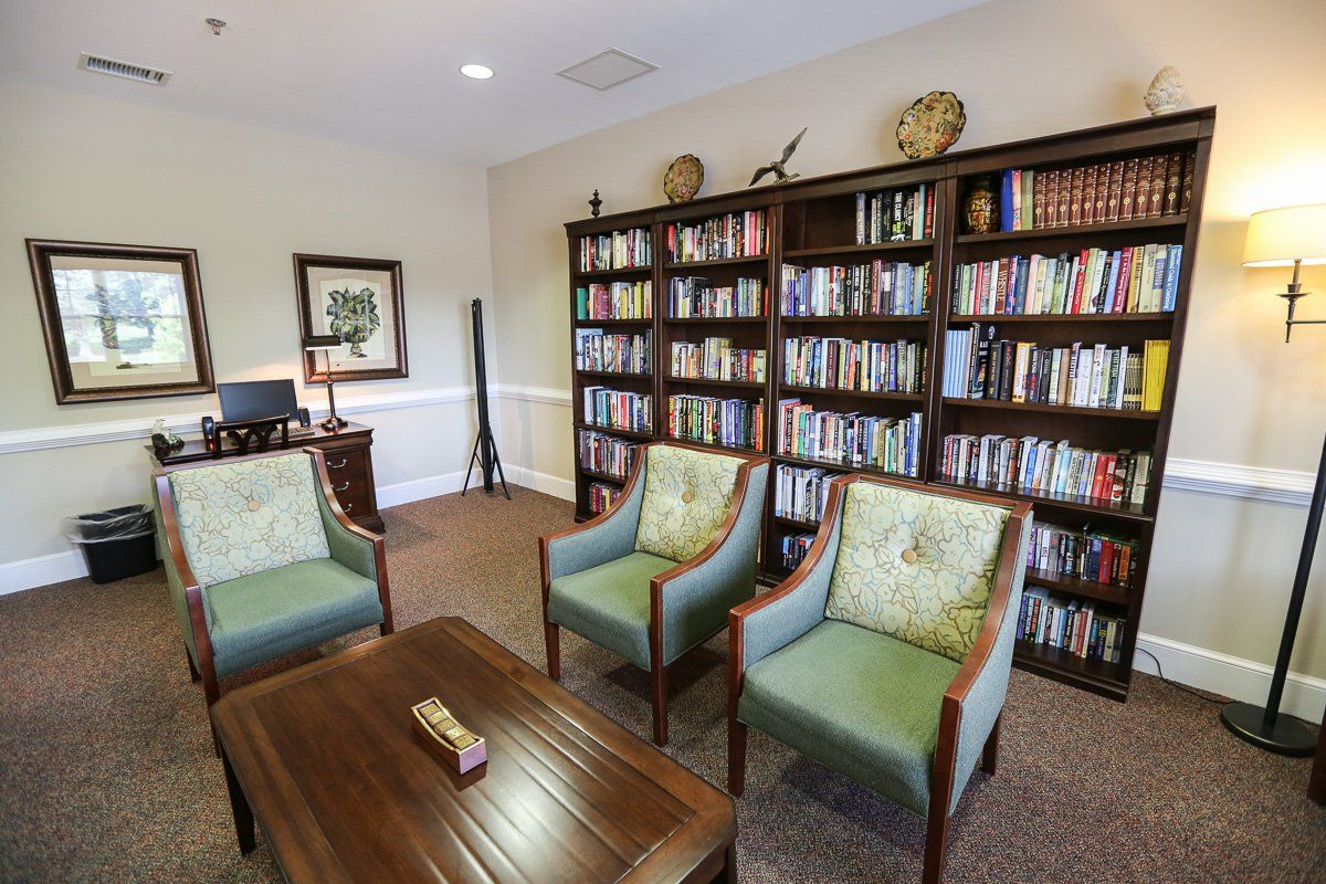 A cozy reading room with bookshelves and comfortable seating.