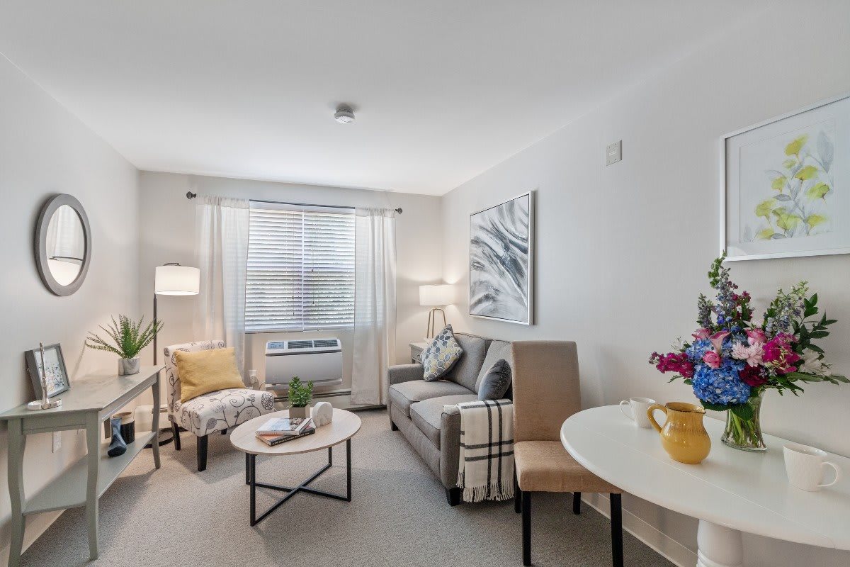 A modern living room with a sofa, decorative artwork, and cozy lighting.