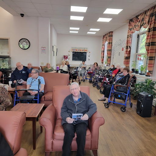 Residents enjoying their time in a care home, engaged in activities and socializing.
