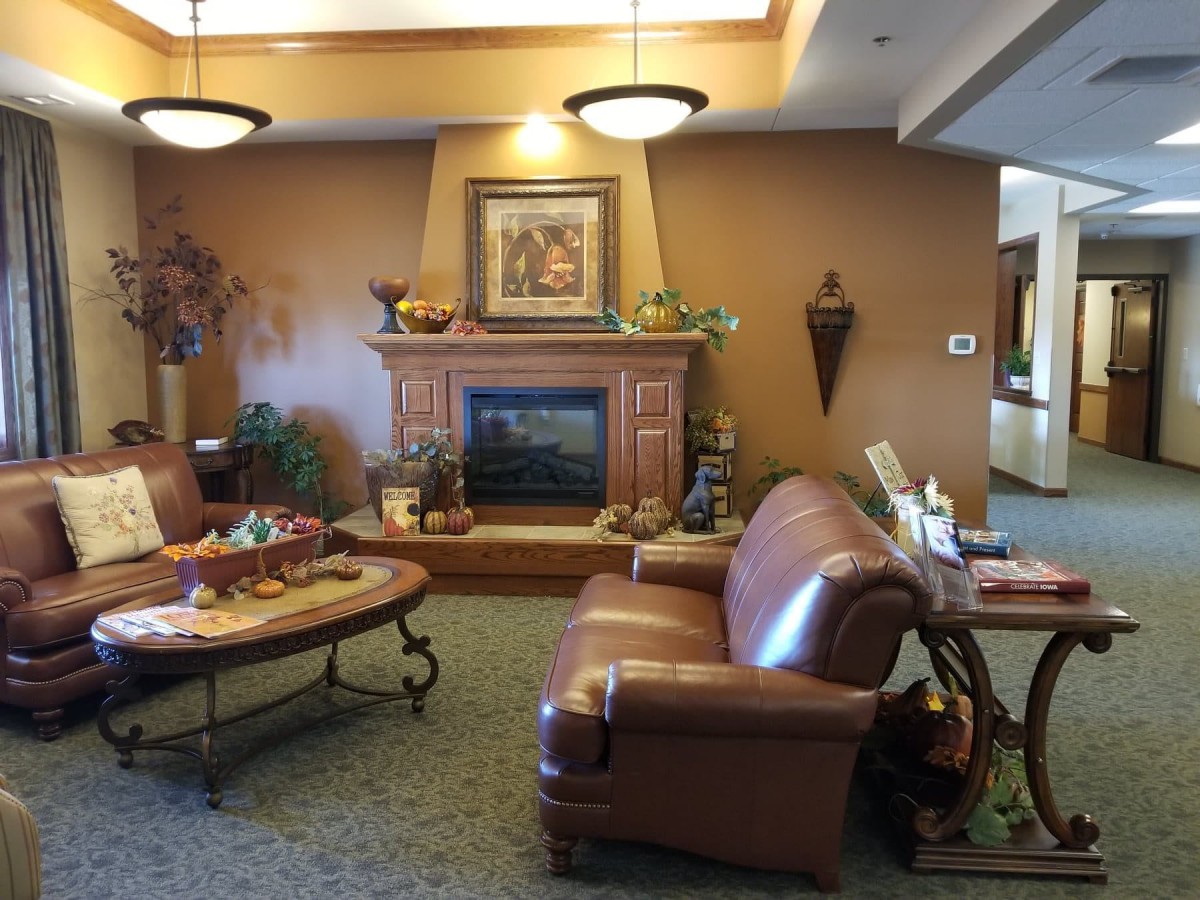 A cozy living room with a fireplace, sofa, and decorative elements.