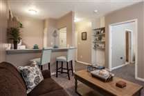 A cozy and modern living room with bar stools and stylish decor.