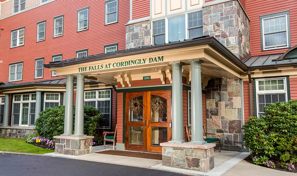 The entrance to a hotel with stonework and columns.