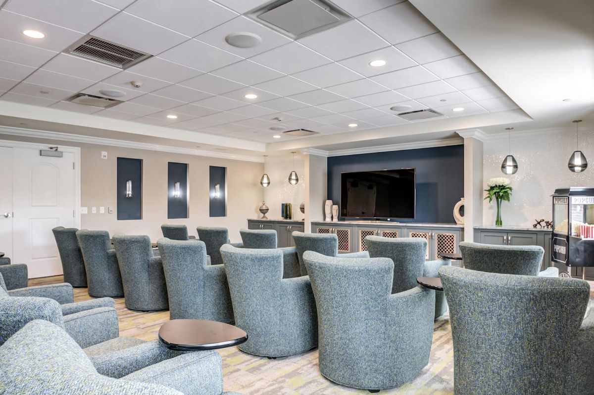 Modern conference room with comfortable seating and a large television for presentations.