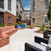 A modern apartment courtyard with seating and landscaped areas.