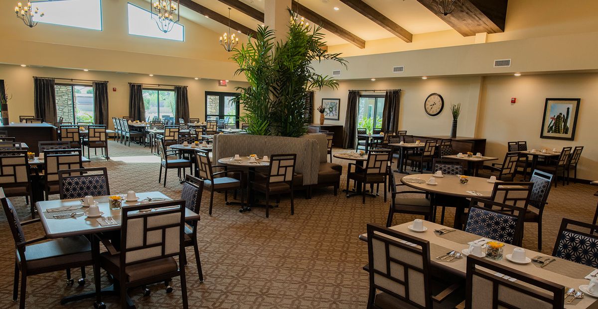 A spacious restaurant interior with neatly arranged tables and chairs.