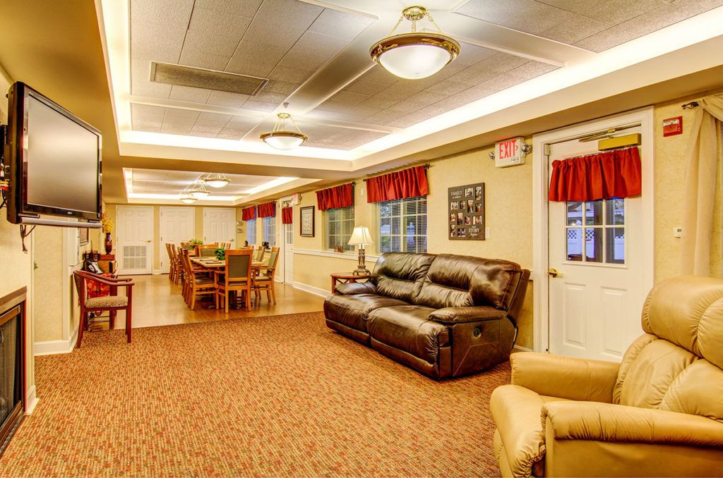 A cozy living room with a couch and dining area.