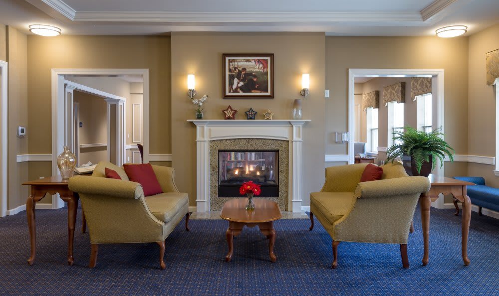 A cozy living room with a fireplace and traditional decor.