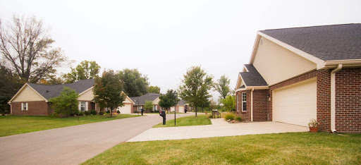 A peaceful suburban neighborhood featuring well-kept houses and lush greenery.