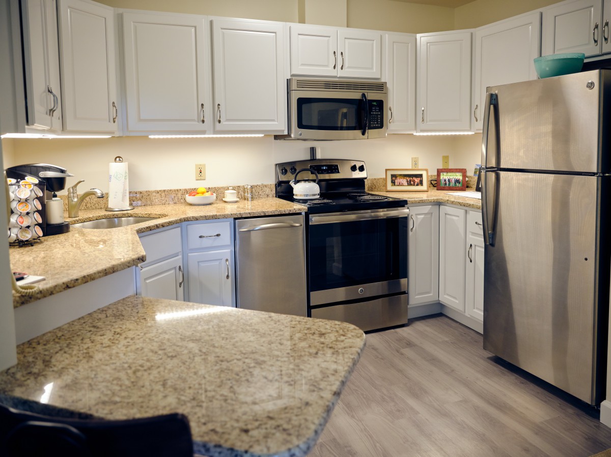 A modern kitchen with stainless steel appliances and granite countertops.