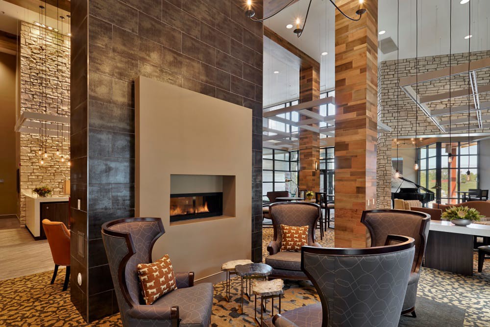 A modern lobby with a cozy seating area and fireplace.