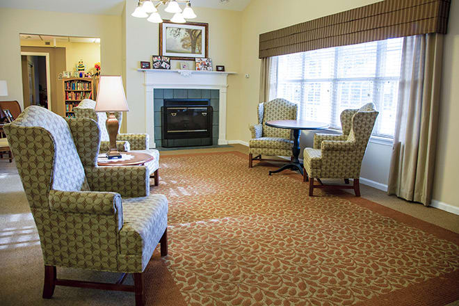Cozy living room with armchairs and a fireplace.