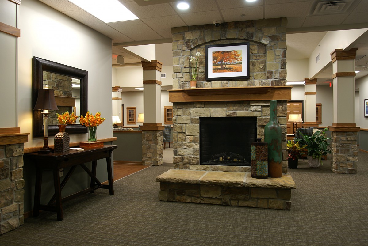 A cozy, modern interior featuring a stone fireplace and stylish decor.