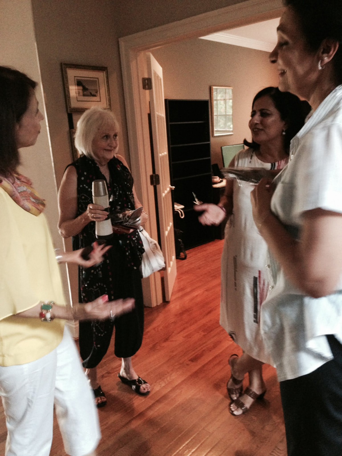 A group of women socializing indoors at a gathering.