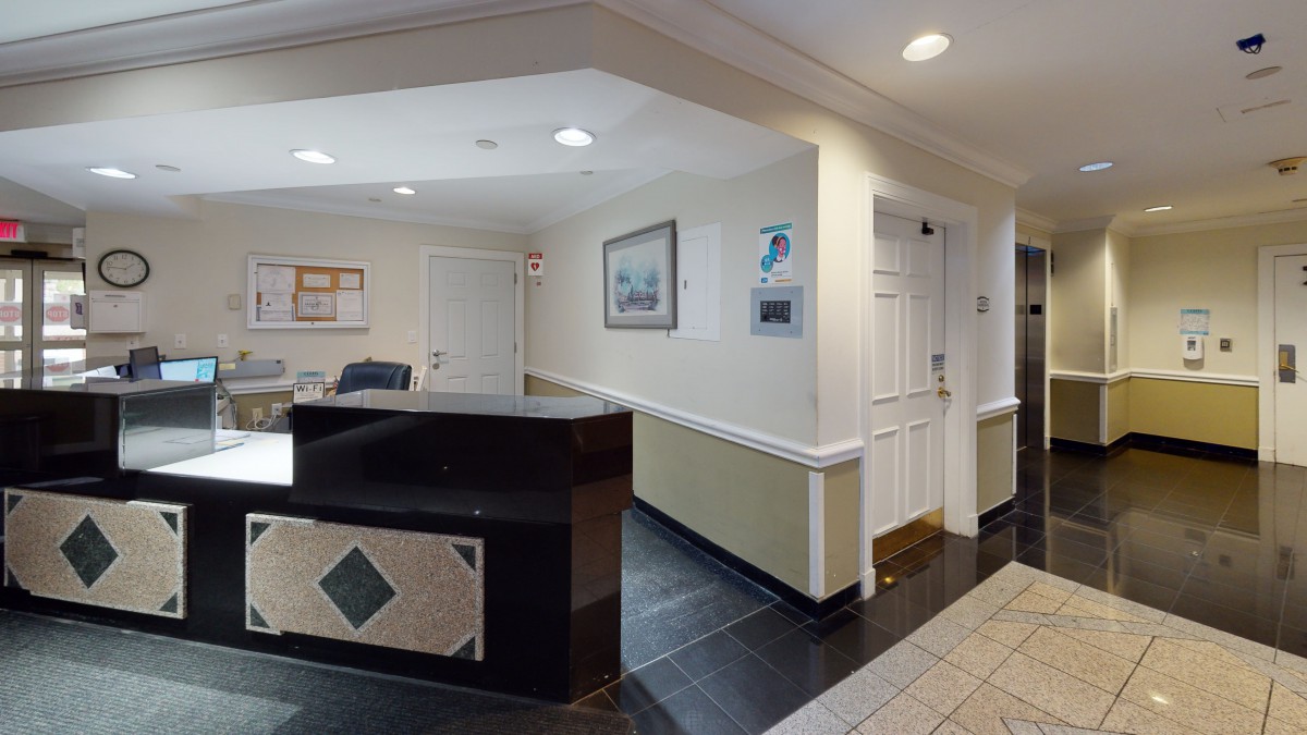 A welcoming office reception area with a front desk and framed artwork on the walls.