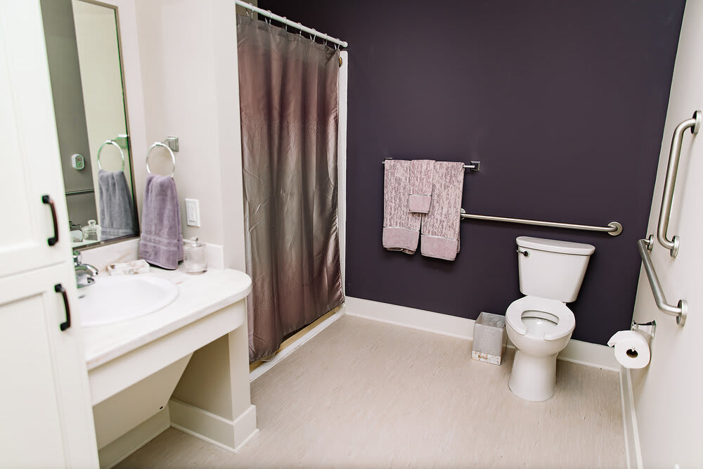 A modern bathroom with a shower, toilet, and sink area.