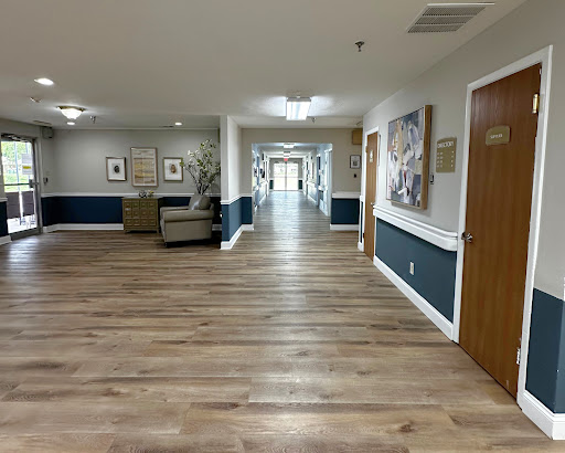 A well-lit hallway featuring wooden flooring and modern decor.