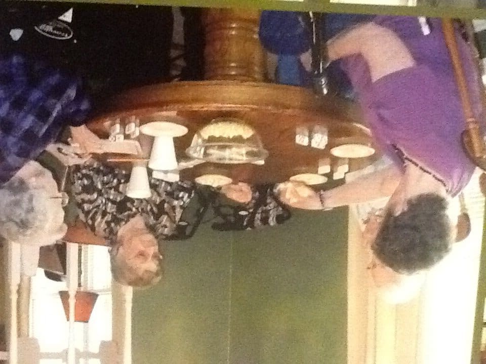 A group of people enjoying a meal and conversation at a restaurant.