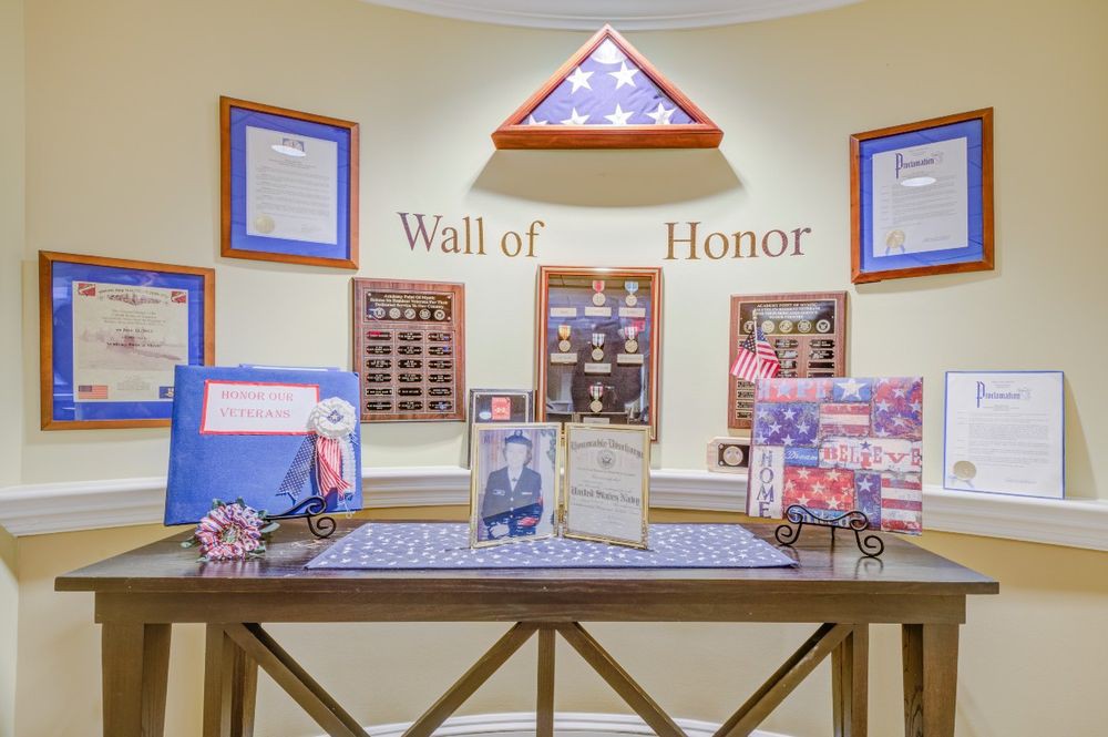 A Wall of Honor display featuring military memorabilia and plaques in tribute to service members.