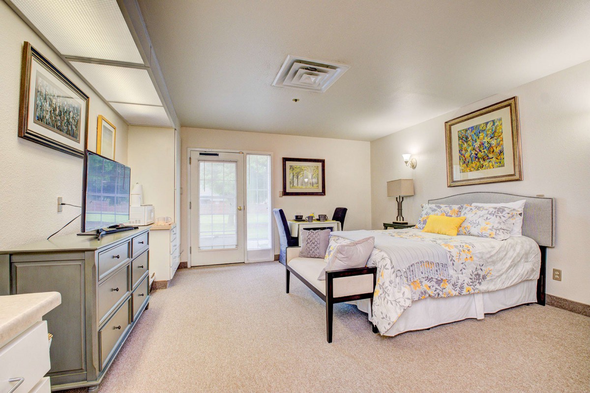 A bright and spacious bedroom with elegant decor and modern furnishings.