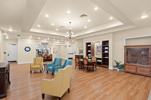 A modern living room with comfortable seating and a chandelier.