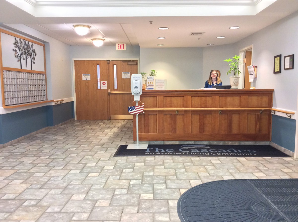 A reception area with a front desk in a lobby setting.