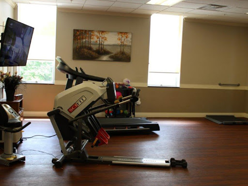 A spacious gym area featuring a treadmill and a rowing machine, perfect for a complete workout.