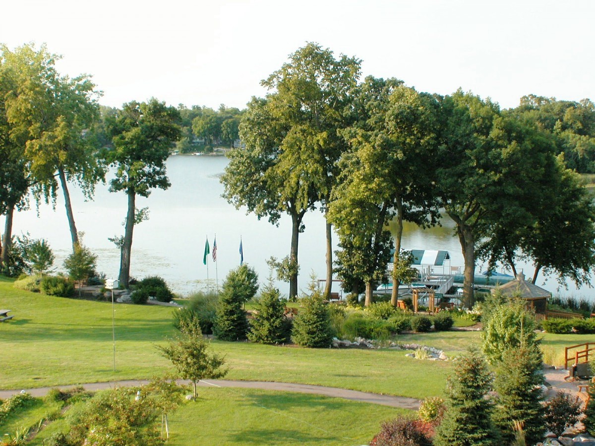 A tranquil lakeside scene with lush greenery and calm waters.