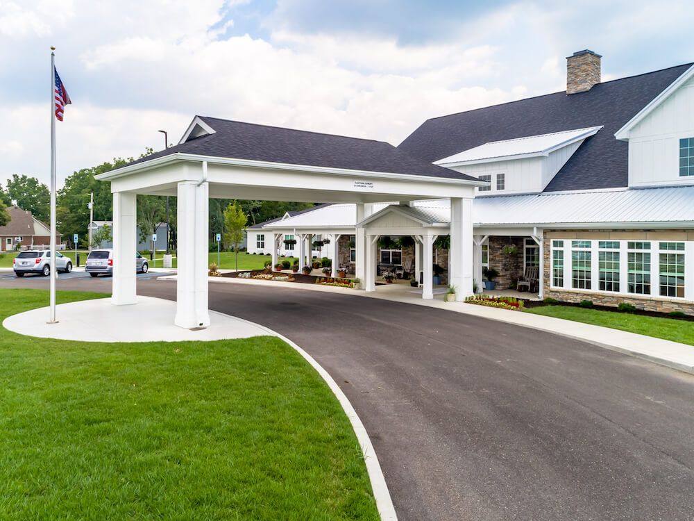 A modern building with a covered entrance and well-maintained driveway.